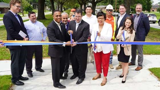CITY CUTS RIBBON ON FLEUR DE LIS DRIVE IN WEST END NEIGHBORHOOD